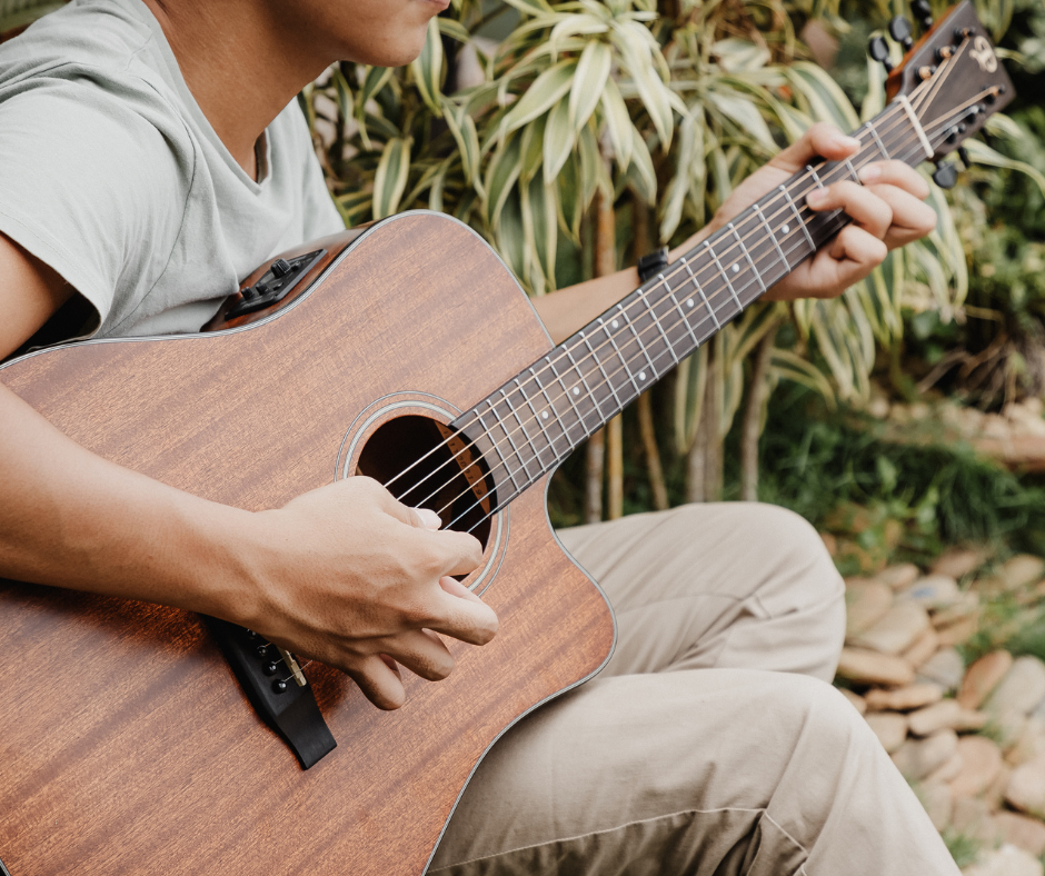 Person playing guitar outside