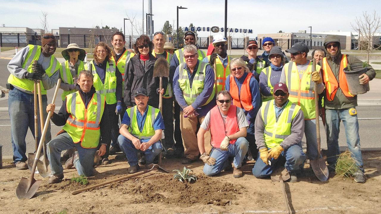 Arboretum and Public Garden staff, including  Kathleen Socolofsky, assistant vice chancellor and director of the Arboretum, stand in front of Aggie Stadium.