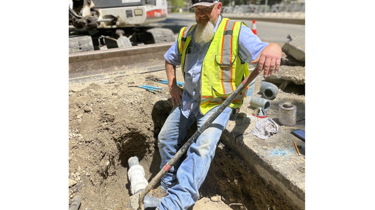 Person in a small trench working on irrigation