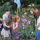 Image of Arboretum Ambassadors with children in the Nature's Gallery Court garden.