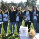 Arboretum Ambassadors student interns pose in front of their investigation station.