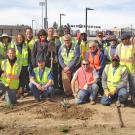 Arboretum and Public Garden staff, including  Kathleen Socolofsky, assistant vice chancellor and director of the Arboretum, stand in front of Aggie Stadium.