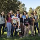 group of interns holding tools after a tree planting