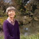 Karen Slinkard posing in front of the Arboretum Waterway