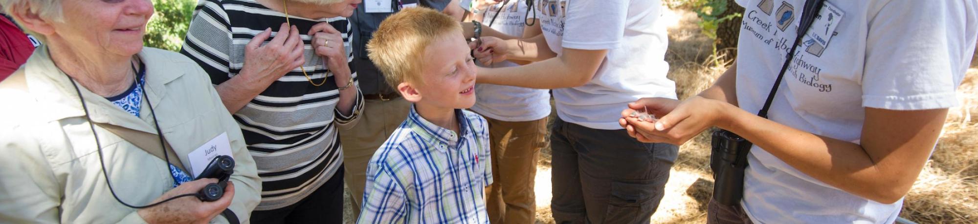 Image of students leading bird banding event in the UC Davis Putah Creek Riparian Reserve.